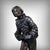 This charming bronze with a brown patina depicts Pierrot as a musician, captured in a moment of carefree joy. The figure,...