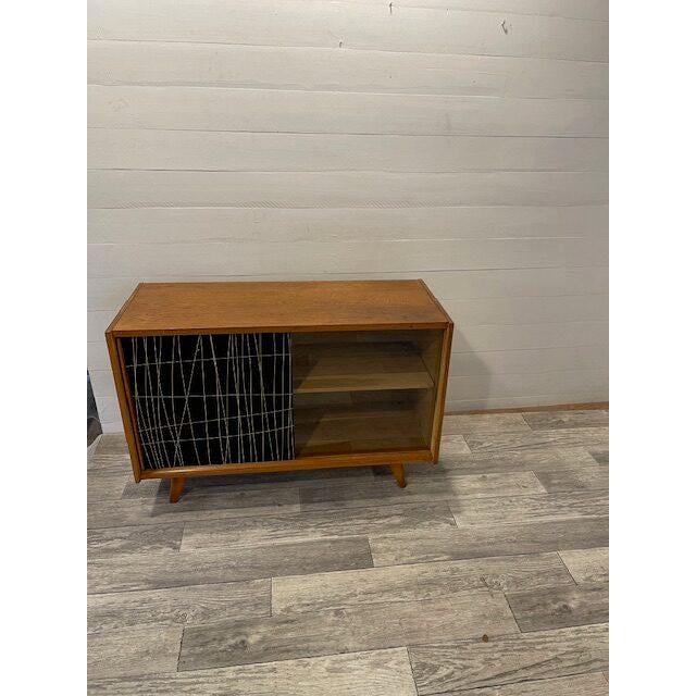 A- 68 retro/vintage sideboard by jiroutek model u-450 with slide doors original black and transparant glass dims; h= 76 cm...