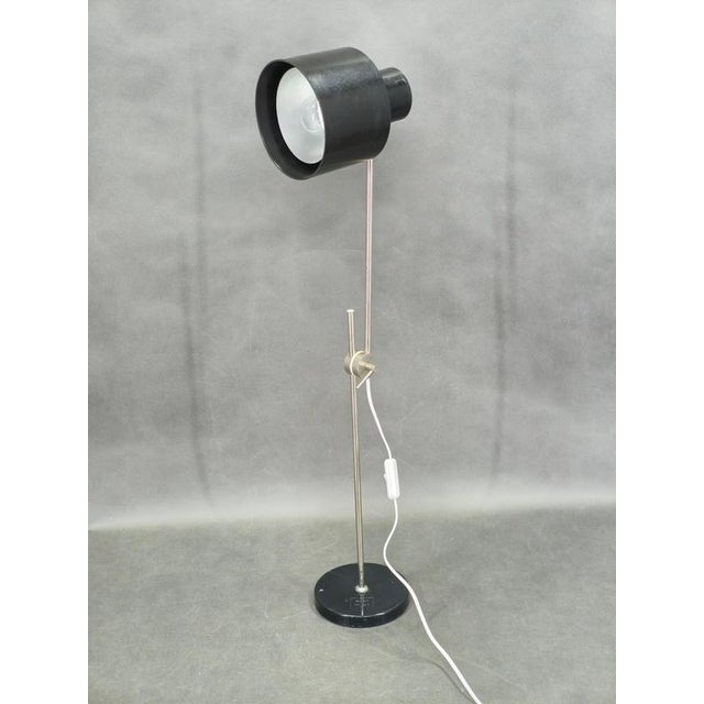 Rare adjustable table lamp model 1012 produced by elektrosvit in czechoslovakia during the 1960s featuring a black...