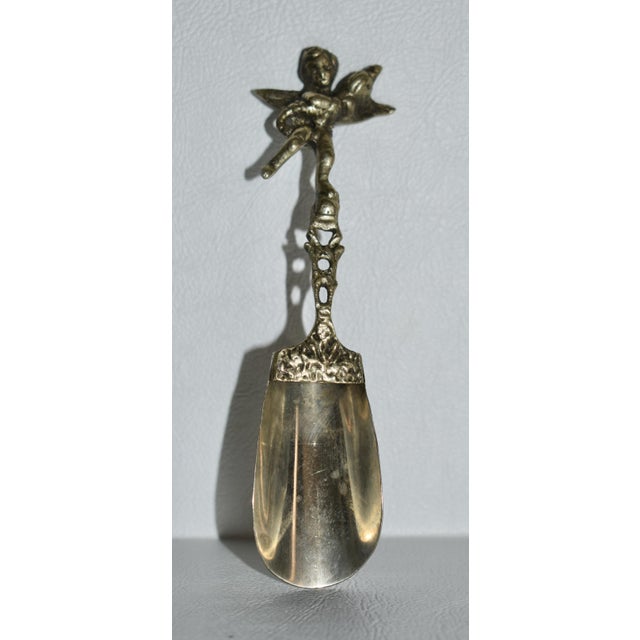 Antique -Late 19th Century Salt Spoon with a Winged Cherub Handle. Made of Silver. The Measurements: 1.5"W x .75"D x...