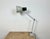 Industrial table lamp made by Elektrosvit in former Czechoslovakia during the 1970s. It features a grey iron base and arm...