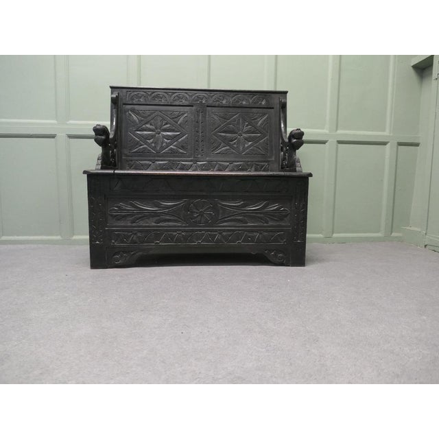 Early 19th Century Carved Oak Box Settle The Settle has carved geometric designs on the back and on the bottom with...
