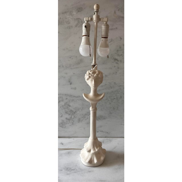 Vintage white painted plaster "Tete de Femme" table lamp in the style of Diego Giacometti. Unsigned. The lamp features two...