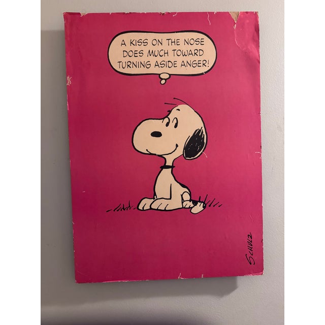 Charming vintage Peanuts wall art featuring Snoopy and an iconic, gently humorous quote attributed to the beloved world...