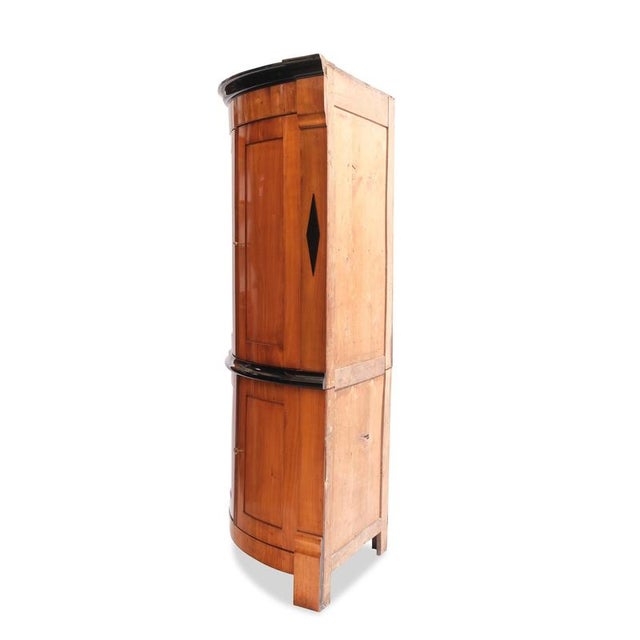 Two-piece Biedermeier corner cabinet, circa 1810, made of cherry wood with four doors. Height 217 cm, width 120 cm, side...