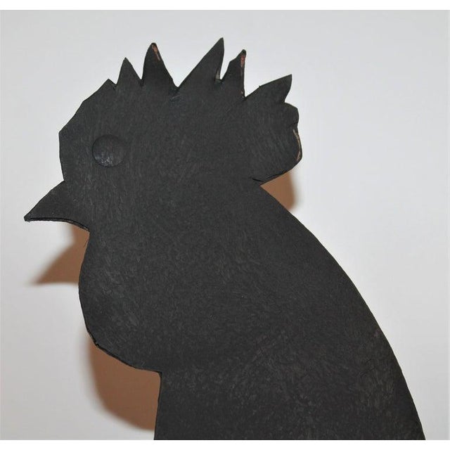 Handcrafted rooster weather vane on a wood plank base. This is a early hand cutout vane.