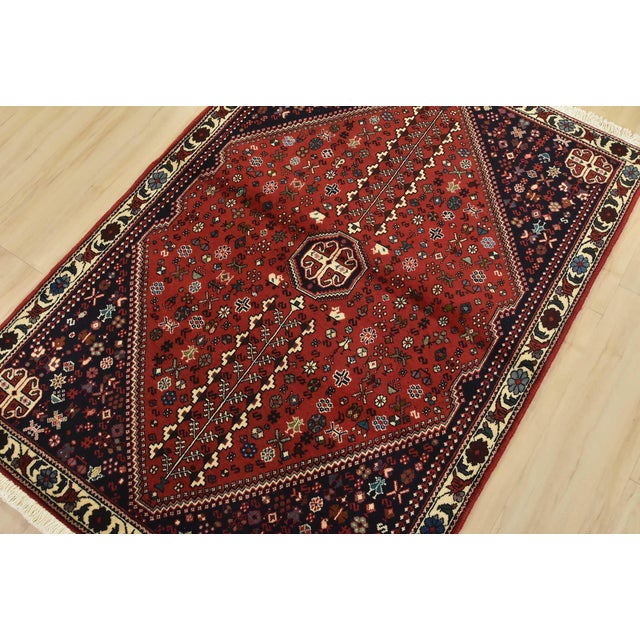An authentic vintage tribal Abadeh rug hand-knotted with fine wool and natural dyes. This intricately woven rug features a...