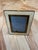 An elegant tabletop picture frame with a wide ivory-colored border, mitered corners, and a warm brass-tone inner trim. Its...