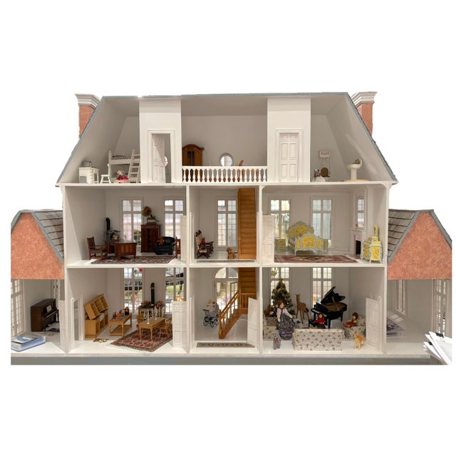 This large furnished dollhouse is a vintage piece with a multicolor French Provincial style. The kit was bought in the...