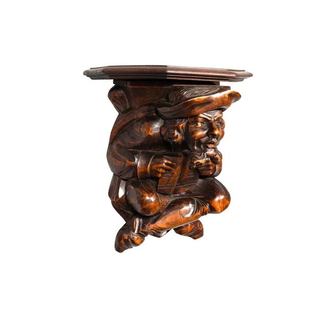 Victorian Walnut Figural Wall Bracket featuring a figure of a man holding a book with his legs crossed. Shelf with...
