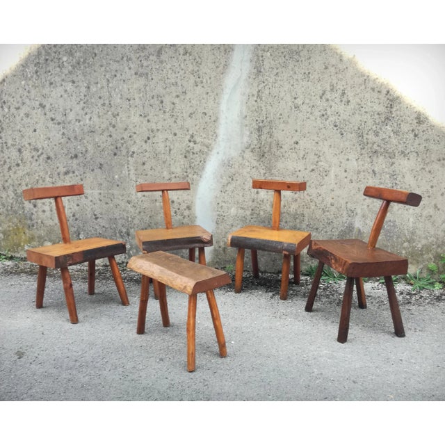 A set of four brutalist chairs made by a french craftsman in the 1960s. these oak and beech chairs feature a thick, solid...