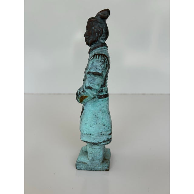 Bronze replica of a Chinese Terracotta Warrior statue, modeled after the ancient figures found in the tomb of Qin Shi...