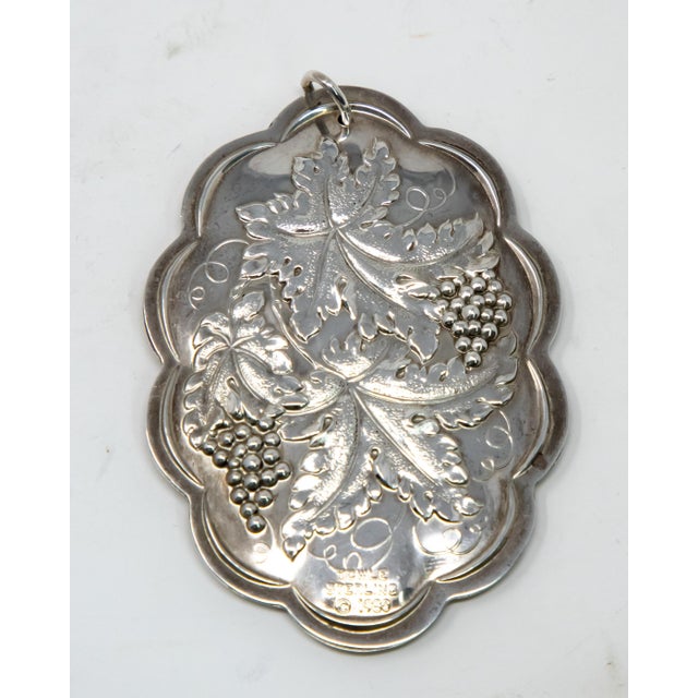 Offering this beautiful Towle sterling ornament from 1980. In an elongated shape the back has floral, foliate and grape...