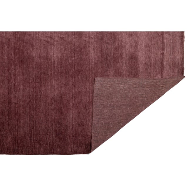 Discover our stunning handcrafted Gabbeh-style wool rug, showcasing a rich Deep Plum design. Proudly part of our Desert...