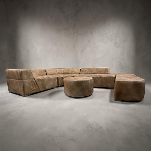 Soft geometry, low proportions, and a warm tobacco-toned finish come together in this one-of-one LOOM modular sectional....