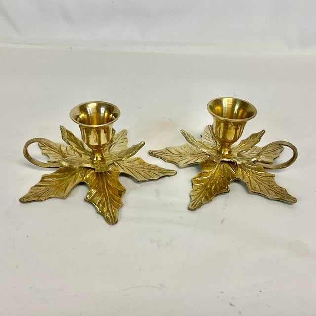 These are a pair of Vintage Christmas Poinsettia Brass Candle Holders. They feature stacking Poinsettia petals that hold...