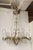 This exquisite French mid-20th-century chandelier brings timeless elegance to any space with its harmonious blend of brass...