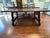 Elegant Spanish/Tuscan-style solid maple dining table with a striking curved iron stretcher base and substantial carved...