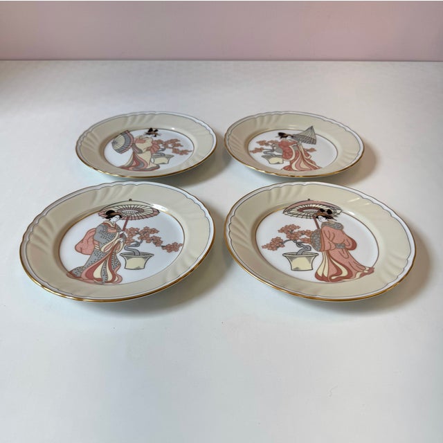 A stunning set of 4 porcelain plates, with gold borders and breathtaking "strolling Geisha" designs by Fitz & Floyd. Each...