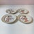 A stunning set of 4 porcelain plates, with gold borders and breathtaking "strolling Geisha" designs by Fitz & Floyd. Each...