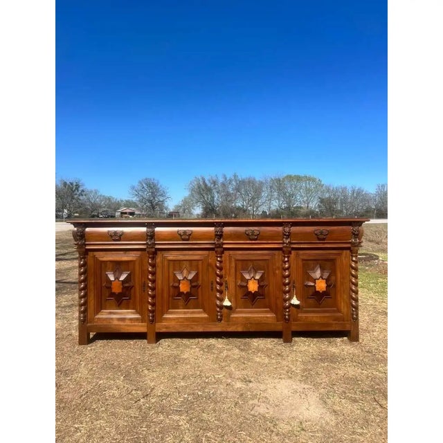 This impressive 19th-century French buffet reflects the bold craftsmanship and rich detailing of provincial design. the...