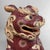 A refined Japanese Kutani shishi, richly decorated with red glaze, gilt accents, and colourful enamelled patterns....