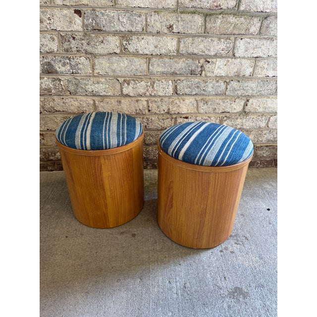 Pair of small scale light wood storage stools from the 1960s, newly reupholstered in an African blue striped textile. The...