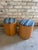 Pair of small scale light wood storage stools from the 1960s, newly reupholstered in an African blue striped textile. The...