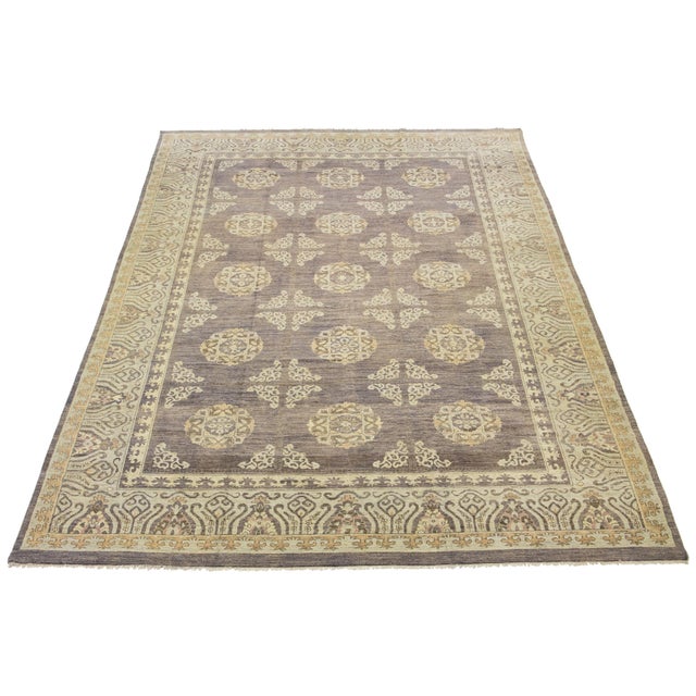 This exquisite modern Khotan-style hand-knotted wool rug features a blue and beige field. It is elegantly bordered with...