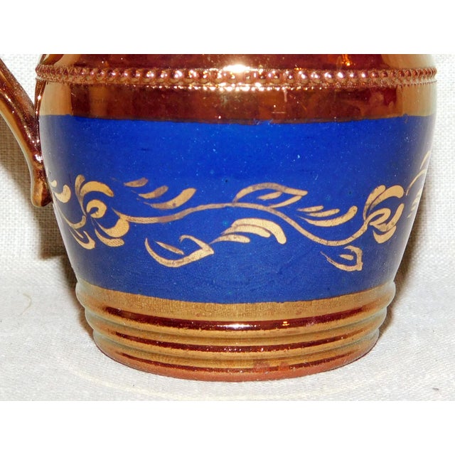 Lovely antique English copper luster creamer with blue band with vine patterning. Such a charming addition to your table!