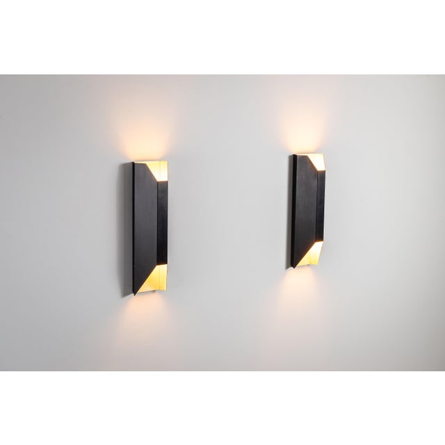 This striking pair of vintage architectural wall lamps embodies the refined confidence of geometric modernism. Defined by...