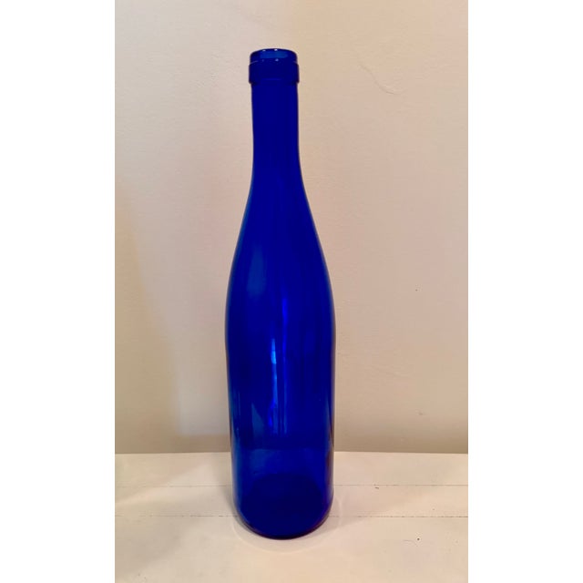 Set of three long neck vintage bottles in light aqua, cobalt blue and dark green. Slender and elegant, these will add...