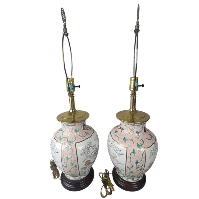 A matched pair of vintage chinoiserie porcelain ginger jar table lamps. Blush pink ground with white reserve panels...