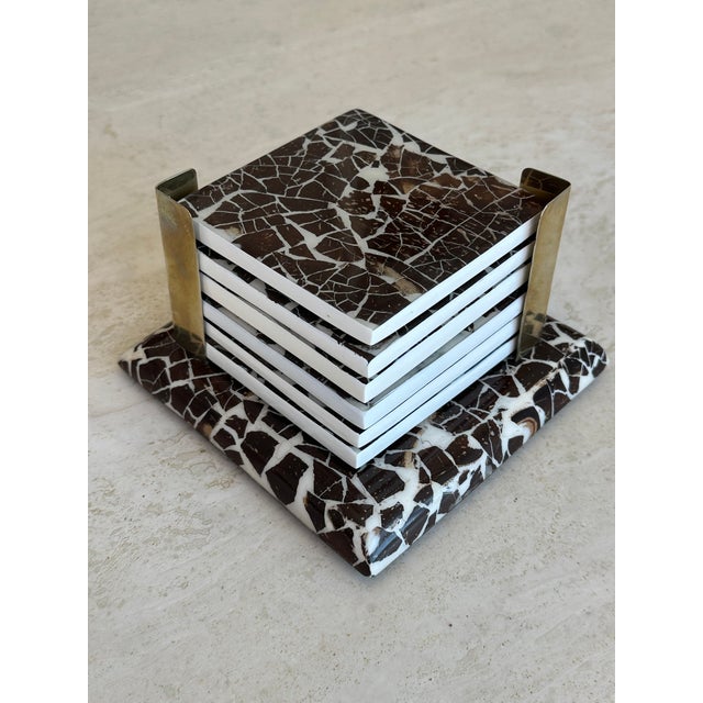 Handcrafted coaster set made of wood and natural coconut shell from Colombia. Sun-dried coconut shells are inlaid on wood...