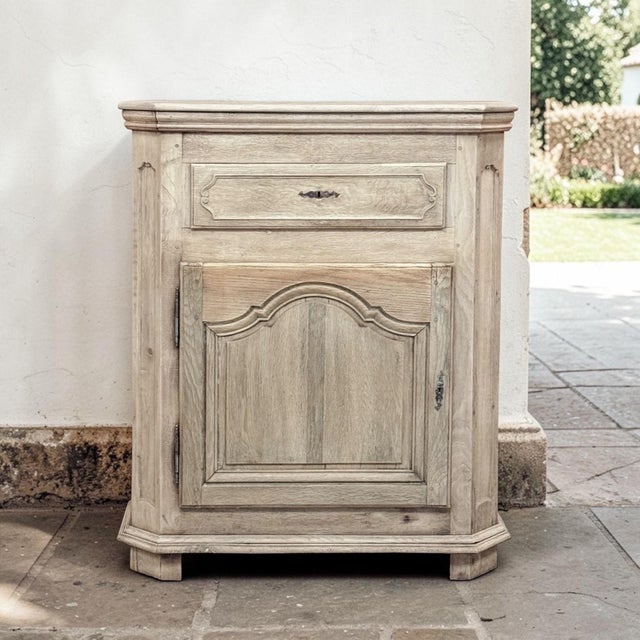 An 18th century Country French Louis XV confiturier in stripped oak, revealing the pale, sun washed beauty of the wood...