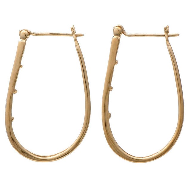 These dazzling, channel-set diamond hoop earrings are a must-have accessory. Whether you're dressing up for a special...