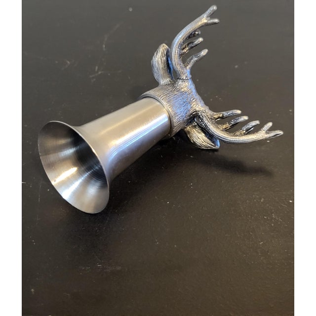 Made from heavy stainless steel, this shot glass is designed with a carved version of the company’s well-known deer head...