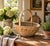 A beautifully preserved early 20th-century egg gathering basket, handwoven in splint oak with a tall bentwood handle and...