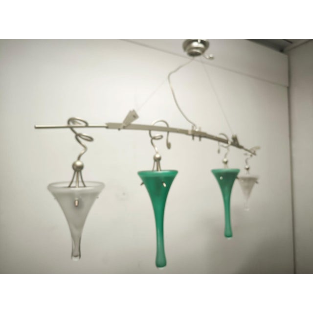 Four-Light Suspension Lamp International, 1990s, in Very Good conditions. Designed 1990 to 1999 This piece has an...