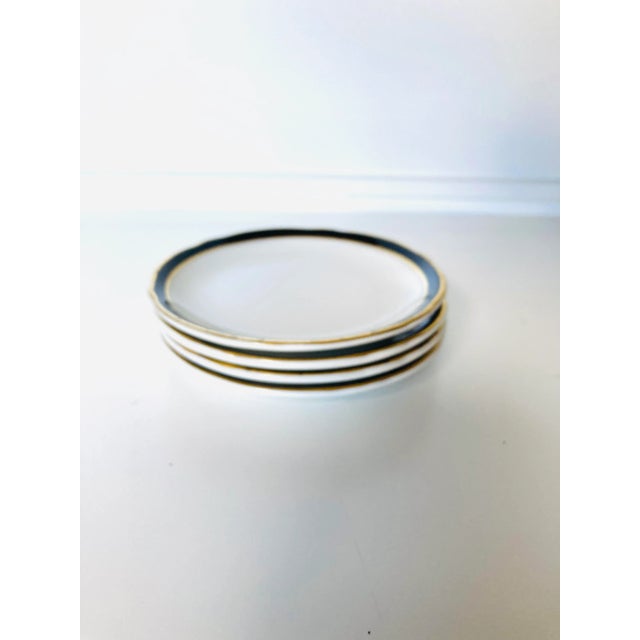 Vintage set of 4 black & gold rimmed white dessert or bread plates 6.5"D , Makers mark reads " Jackson China" Very good...