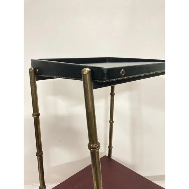 Leather and brass-covered side table by Jacques Adnet I have official proof of authenticity such as vintage catalogs,...