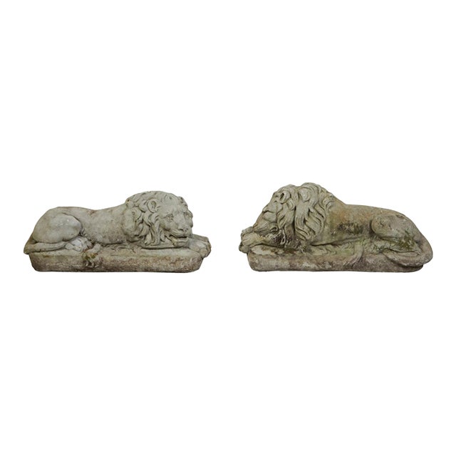 Pair of English 1920s Cast Stone Reclining Lion Sculptures on Conforming Bases For Sale