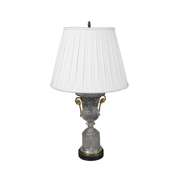 Exceptional pair of vintage neoclassical crystal urn table lamps by Baccarat. These beautiful lamps come from the original...