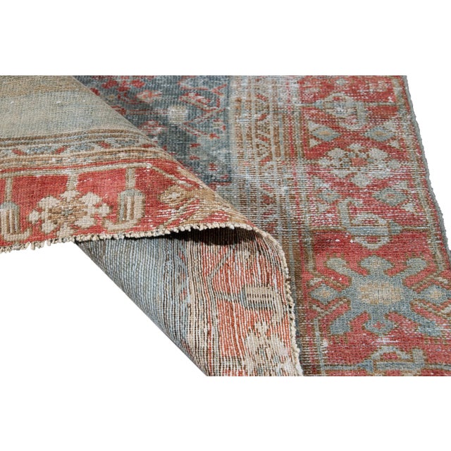 Beautiful vintage Persian Malayer hand knotted wool runner with a blue field. This Malayer runner has accents of red and...