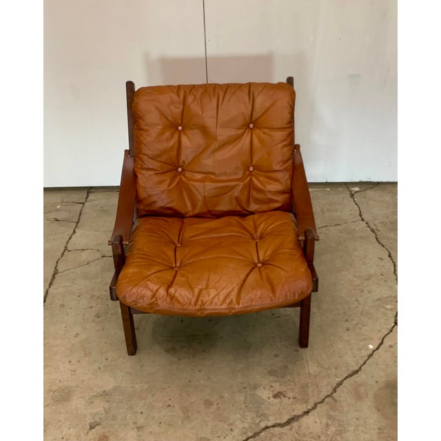 Hunter chair Attributed to Torbjørn Afdal for Bruksbo Norway, 1960s. Wood frame with leather cushions on canvas tied to...