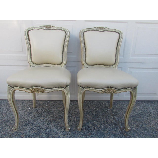 Set of six painted French dining chairs, c.1930’s Comprising of two armchairs and four side chairs. Having a painted white...