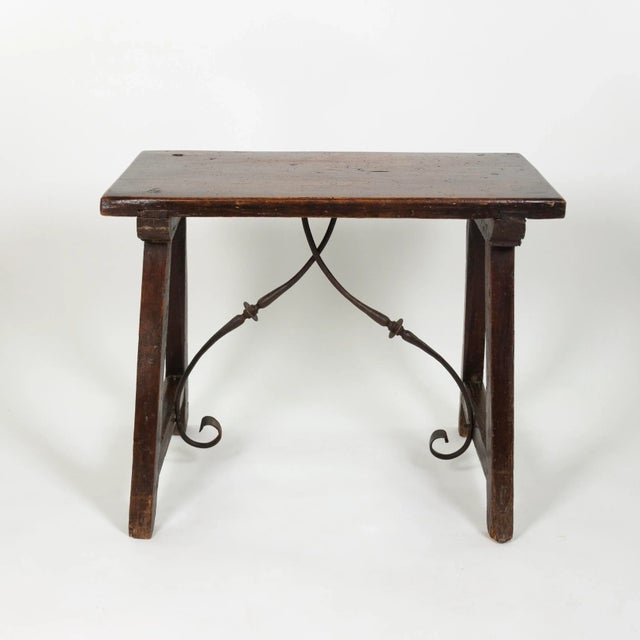 Small-scale Spanish walnut trestle table with iron stretcher circa 1850 height: 24.5 in. (62 cm) width: 29 in. (74 cm)...