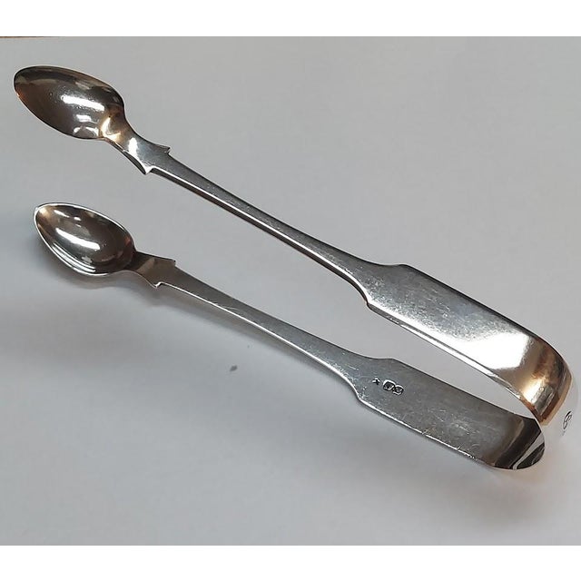 Fine antique George III sterling silver sugar tongs, hallmarked in Newcastle upon Tyne for the 1801-1802 assay year....