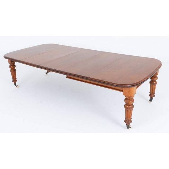 A handsome blonde oak Victorian extending dining table of generous proportions The table stands upon elegant ring-turned,...