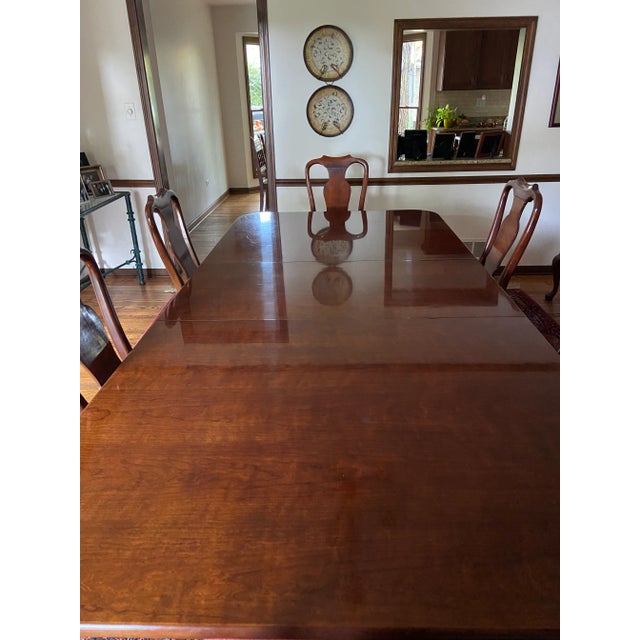 This is a beautiful solid mahogany double pedestal dining table by Henredon that has 2 arm chairs and 6 side chairs, along...